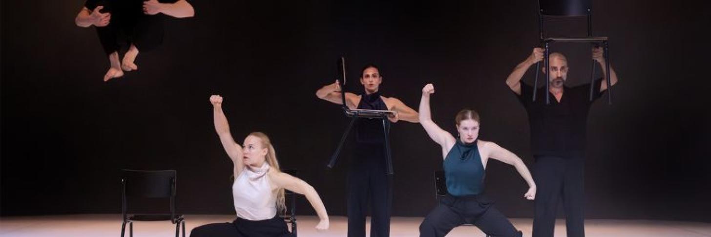 Groupe de danseurs sur sc&egrave;ne avec des chaises 